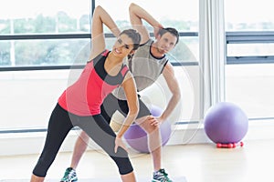 Two people doing power fitness exercise at yoga class