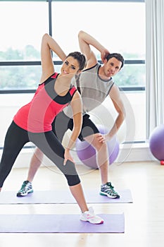 Two people doing power fitness exercise at yoga class