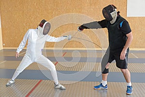 Two people and fencing dual
