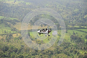 Two people flying in autogyro