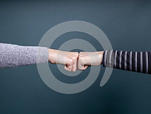 Two people greeting each other with knuckles