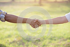 Two people Handshake in the garden fields