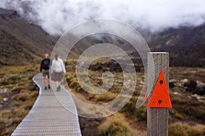 Two people hiking the Tongariro Alpine Crossing