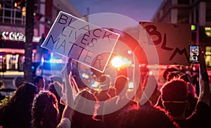 BLM signs are held infront of police cars during protest