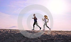 Two people jogging at sunset