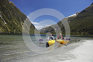 Two People Kayaking In Mountain Lake
