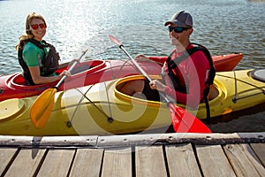 Two people in kayaks on the river