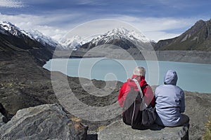 Two people looking at Tasman Glacier and Tasman Lake, New Zealand