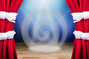 Two People Opening Red Stage Curtain