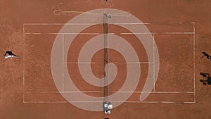 two people Playing Tennis on Tennis Court aerial view