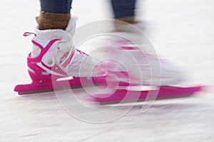 Two people skate on the ice.