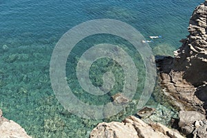 Two people snorkeling in deep blue sea