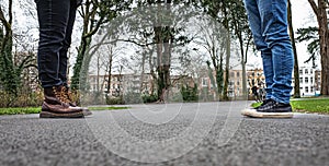 Two people standing at a safe distance opposite each other - social distancing