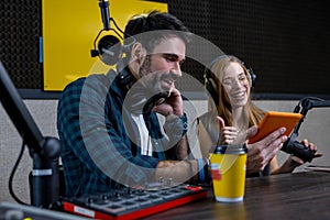 Two people at the studio preparing a radio program