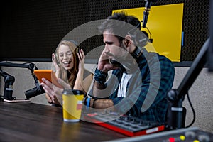 Two people at the studio preparing a radio program