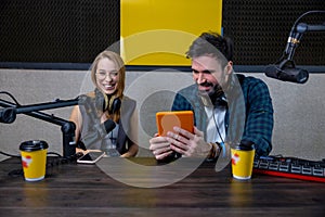 Two people at the studio preparing a radio program