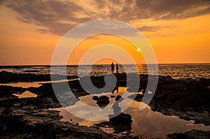 Two people at sunset in Twostep, Hawaii, USA