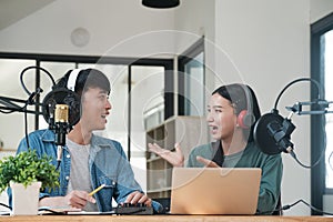 Two people are talking on a microphone