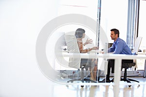 Two people talking in an office photo