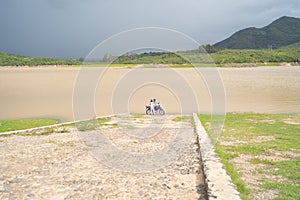 Two people with their motorcycle on the Corrinchis Dam in Mascota Jalisco. photo