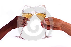 Two people toasting with glasses of white wine