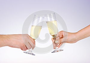 Two people toasting with wine glasses