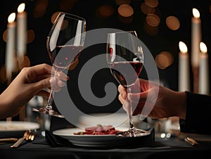 Two people toasting wine glasses at a dinner table