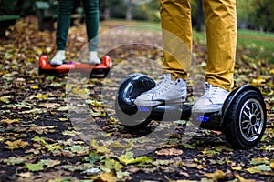 Two people are using hoverboards