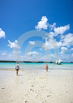 Two people, walking on the beach in the famous Upi bay, Pines Island, new caledonia