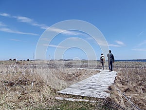 Two people walking down a trail