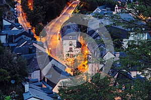 Two people are walking in  Grund Quarter in Luxembourg City during night