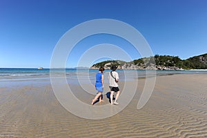 Two people walking on idyllic beach at Florence Bay, Magnetic Island, QLD, Australia