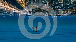 The two people walking through the night snow field on the citylights background.