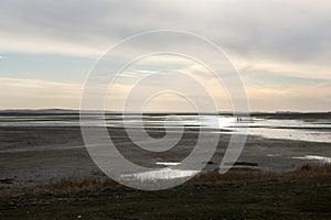 Two people walking a sandbank between Terschelling and Vlieland