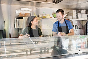 Two people working in food truck