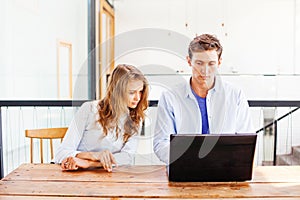 Two people working on laptop