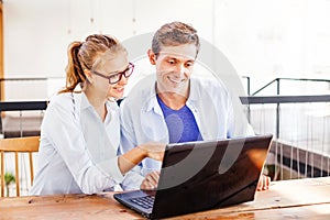 Two people working on laptop