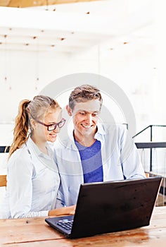 Two people working on laptop