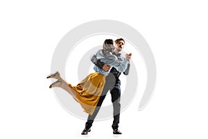 Two people, young man and woman in vintage attire dancing rock-and-roll isolated on white background