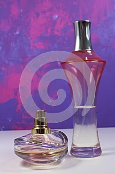 Two perfumes with white pearls