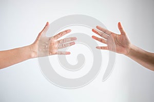 Two person playing rock paper scissors with both posturing paper symbol on white background