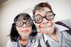 Two person wearing spectacles in an office at the doctor