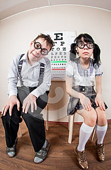 Two person wearing spectacles in an office at the doctor