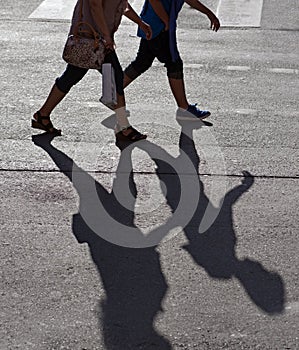 Two persons crossing street