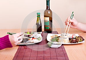 Two persons eating sushi