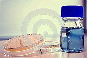 Two petri dishes and a bottle