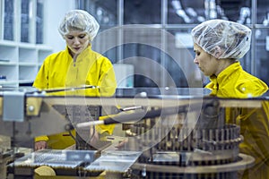 Two Pharmaceutical Factory Workers Wearing Protective Work Wear photo