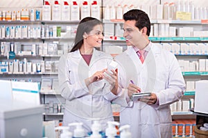 Two pharmacists in modern pharmacy