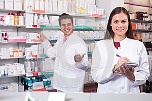 Two pharmacists in modern pharmacy