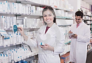 Two pharmacists in modern pharmacy